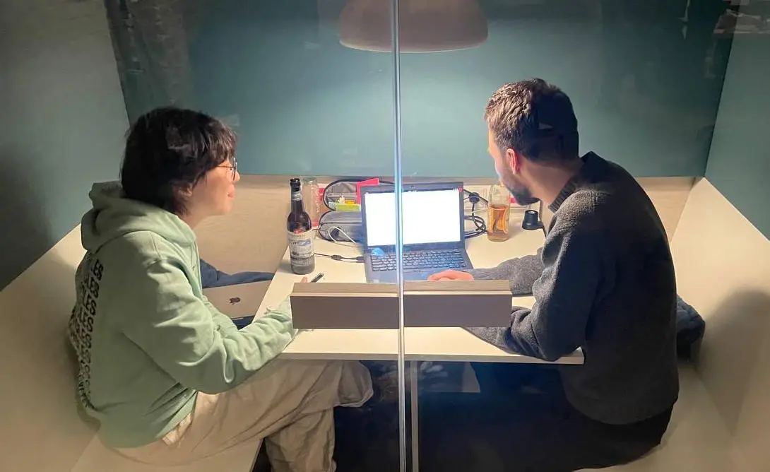 Eileen and Sebastian in a call booth at Cultivation Space doing user testing on Reflection.